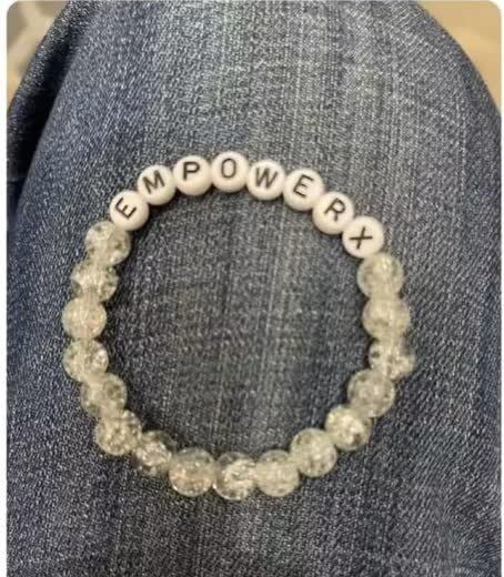 A close-up of the EmpowerX letter-bead bracelet