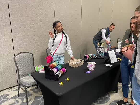 Maddison greeting customers at her conference booth